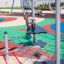 Boy playing on the Wonderland Trim Trail playground equipment.