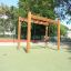 Classic Nature Trim Trail on a playground with green surface.