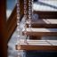Wooden steps of Classic Nature Trim Trail playground equipment suspended by chains.