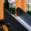 Wooden playground structure with black slide of Challenger Aztec Nature II.
