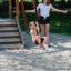 Medium Cableway with platform playground equipment with child riding on it and adult supervising