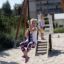 Children playing on Medium Cableway with platform in a sandy playground