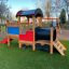Locomotive with slide train playhouse on playground.