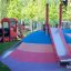 Locomotive with slide train playhouse in a colorful playground.