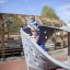 Children playing on the Aztec play loop steel structure.