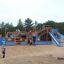 Bounty ship with slide in a playground surrounded by children playing