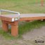 Wooden Gymnastic bench with metal handle in outdoor fitness area