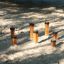 Wooden jumping pegs playground equipment in the sand.