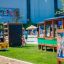 Climbing box wooden playhouse in a busy outdoor playground.