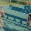 Wooden playground climbing structures and playhouse.