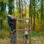 Children playing on a Climbing box wooden playhouse in a forest.