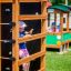 Child playing on Climbing box wooden playhouse in a park.