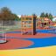 Wooden climbing box playhouse on colorful playground.