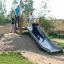 Children playing on Hill Slide Wide h150 in an outdoor park.