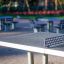 Concrete table tennis, in-ground table in a park setting.