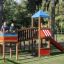 Children playing on Jubilee Unit castle with slide in a park.