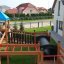 Children playing on the Jubilee Unit castle with slide in a backyard.