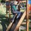 Child playing on Jubilee Unit castle with slide in a park.