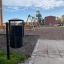 Black City bin in a public playground area.