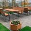 Wooden flowerpot IV on a patio with modern outdoor wooden and metal furniture.