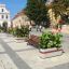 Geneva IV street bench with integrated planter in an urban setting.