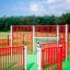Red and white gate fence system on green playground Allianz Arena.