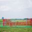 Allianz Arena playground with red metal fence and green floor outdoor