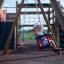 Child enjoying the Swing Frame (double swing) at playground