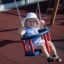 Child enjoying Swing Frame (double swing) at a playground