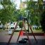 Double swing set in a park with wooden frame and tire seats