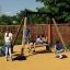 Children playing on a Swing Frame (single swing, wide) in a playground.