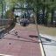 Swing Frame (single swing, wide) with children playing on it at a park.