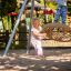 Children playing on a Swing Metal Frame (single swing, wide).