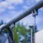 Swing Metal Frame (single swing, wide) close-up with chain details on a playground against a blurred