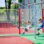 Children enjoying the Swing Metal Frame (double swing) at a playground.