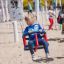 Child using a swing seat: Baby seat at a playground.