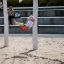 Child enjoying a ride on a red Swing seat: Safety seat in a playground.