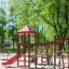 Wooden playground structure with red slide Lemur single slide in park setting