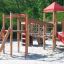 Lemur single slide wooden playground equipment with rope bridge and sand base.