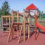 Outdoor playset Lemur single slide with red and wooden structure.