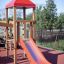 Red playground slide on wooden structure, Lemur single slide.
