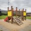 Children's playground Mini play with slide, stairs, and sand base in an outdoor park.