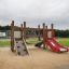 Mini play playground set with slide and climbing wall on sandy surface