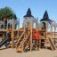 Windsor castle with slide - large playground structure resembling a castle with multiple towers and 