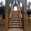 Playground equipment Windsor Castle with slide featuring wooden stairs and medieval castle design.