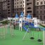 Playground structure Windsor castle with slide and swings in an outdoor residential area.