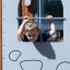 Camelot castle with slide playground climbing panel with child looking through window