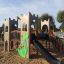 Children's playground Camelot castle with slide in a sandy area