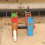 Colorful Camelot castle with slide in a sandy playground area