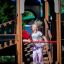 Child playing on Camelot castle with slide in the playground.